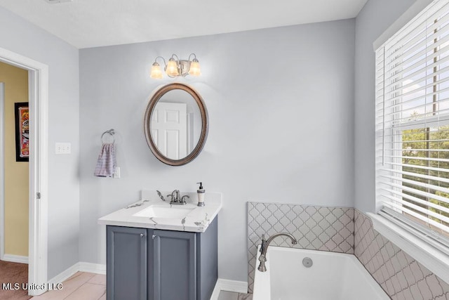 11020 Jordan Dr, Bay Saint Louis, MS 39520 - bathroom featuring a tub to relax in, vanity, and baseboards