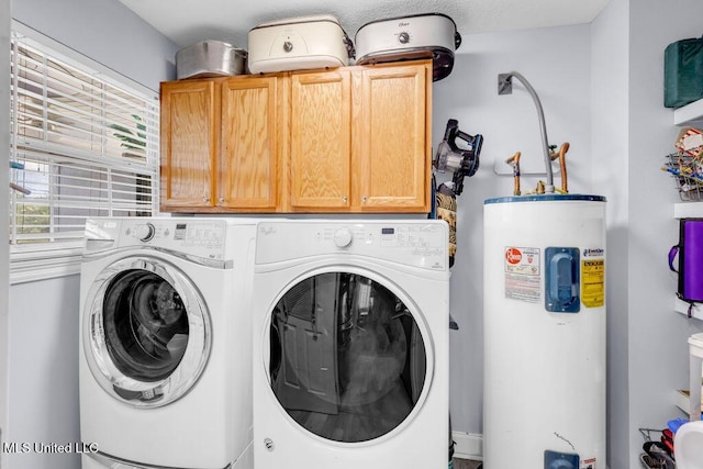 11020 Jordan Dr, Bay Saint Louis, MS 39520 - washroom with electric water heater, cabinet space, and washing machine and clothes dryer