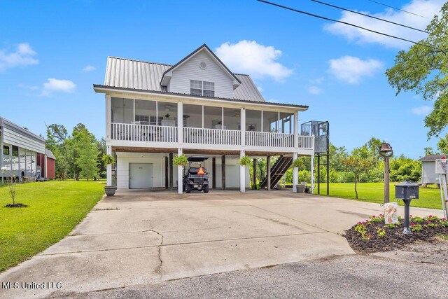 11020 Jordan Dr, Bay Saint Louis, MS 39520 - beach home featuring a sunroom, driveway, a front yard, a carport, and metal roof