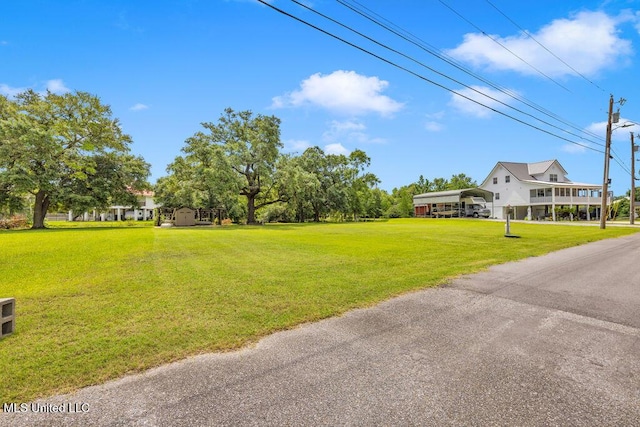 11020 Jordan Dr, Bay Saint Louis, MS 39520 - view of grassy yard featuring a detached carport