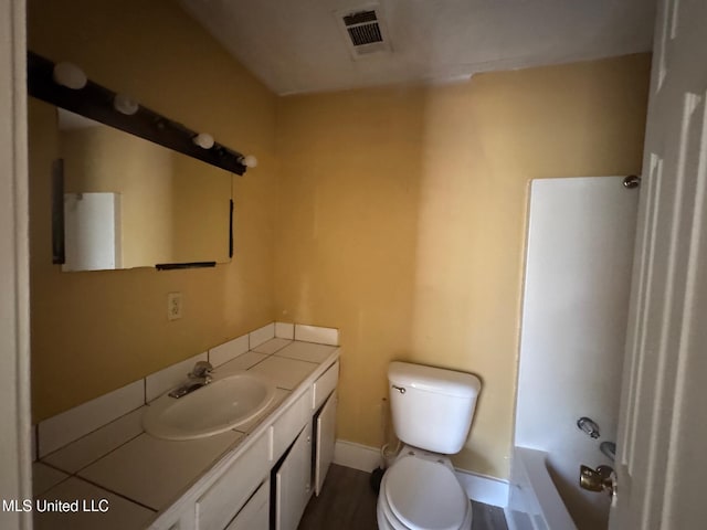 full bathroom with shower / tub combination, vanity, and toilet