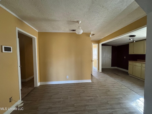 unfurnished room featuring wood-type flooring and a textured ceiling