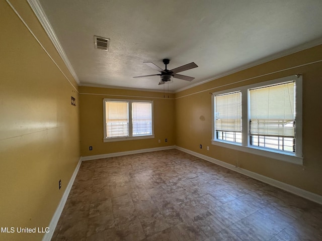 empty room featuring plenty of natural light, ceiling fan, and crown molding