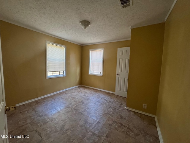 unfurnished room featuring a textured ceiling and ornamental molding