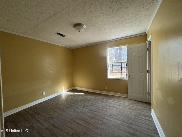 spare room with wood-type flooring, a textured ceiling, and crown molding