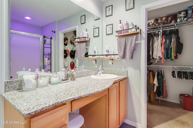 bathroom featuring vanity and a shower with shower door