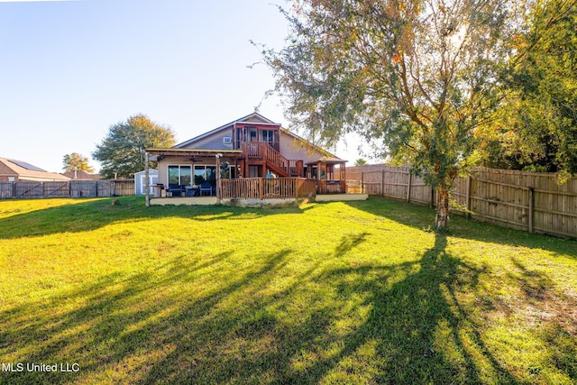 view of yard with a wooden deck and ceiling fan