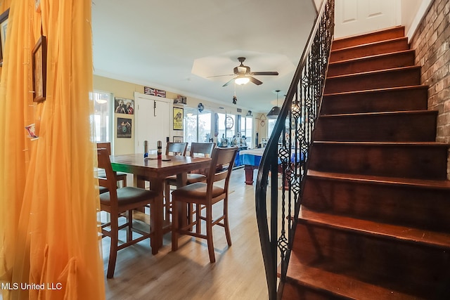 dining room featuring ceiling fan, wood-type flooring, and ornamental molding