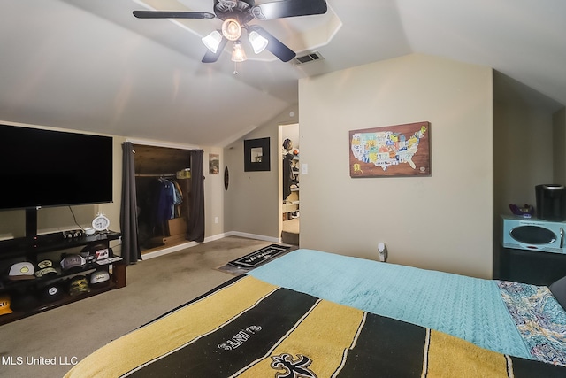 bedroom featuring ceiling fan, a walk in closet, lofted ceiling, and a closet