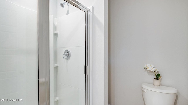 bathroom featuring toilet and walk in shower