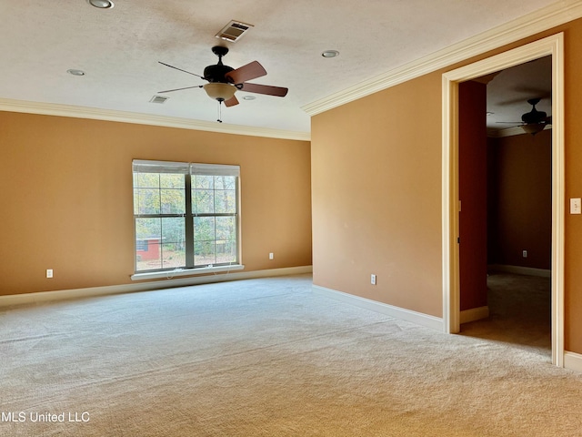 carpeted spare room featuring ceiling fan and ornamental molding