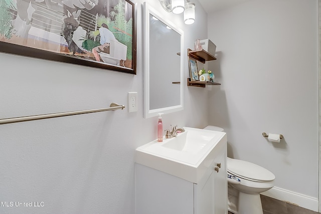 bathroom with toilet and vanity