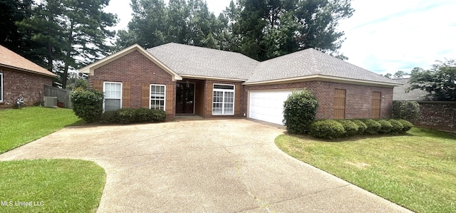 single story home featuring a garage and a front lawn