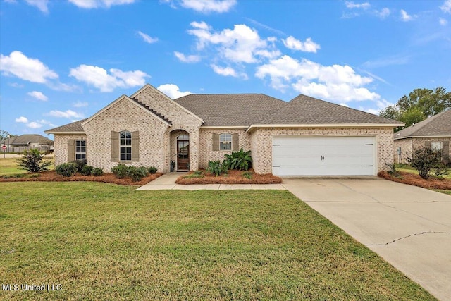142 Western Ridge Cir, Canton, MS 39046 - french country inspired facade featuring driveway, an attached garage, brick siding, and a front yard