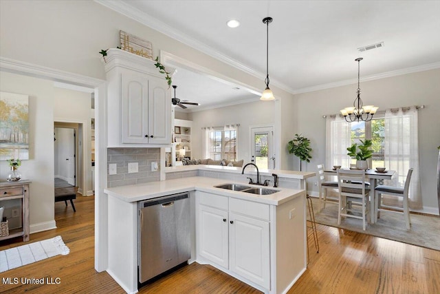 142 Western Ridge Cir, Canton, MS 39046 - kitchen featuring dishwasher, a sink, light countertops, a peninsula, and a ceiling fan