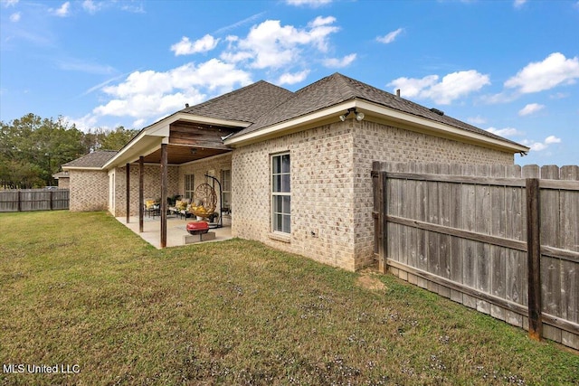 142 Western Ridge Cir, Canton, MS 39046 - rear view of house featuring brick siding, a patio area, and roof with shingles