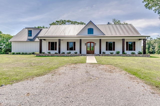 106 Horseshoe Ln, Flora, MS 39071 - modern farmhouse featuring french doors, metal roof, a front lawn, and board and batten siding