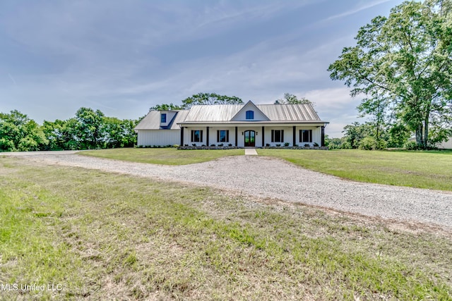 106 Horseshoe Ln, Flora, MS 39071 - modern inspired farmhouse with covered porch, a front lawn, metal roof, and driveway