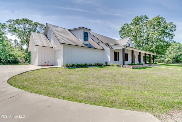 106 Horseshoe Ln, Flora, MS 39071 - modern inspired farmhouse with a front yard, metal roof, a garage, driveway, and board and batten siding