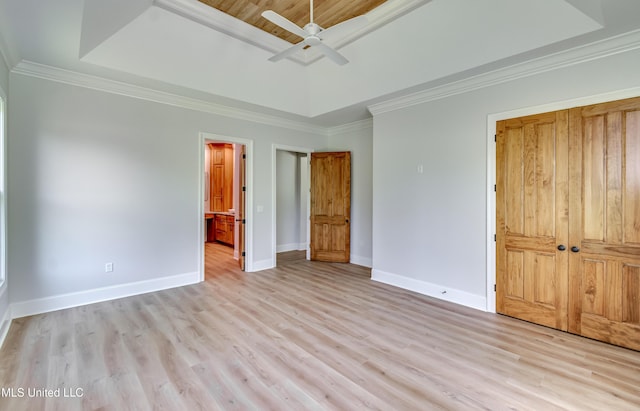 106 Horseshoe Ln, Flora, MS 39071 - unfurnished bedroom with a raised ceiling, baseboards, light wood finished floors, ornamental molding, and connected bathroom