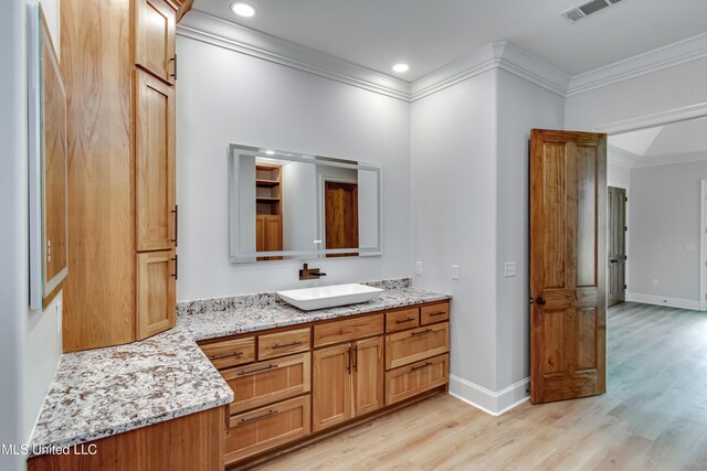 106 Horseshoe Ln, Flora, MS 39071 - bathroom featuring wood finished floors, ornamental molding, vanity, baseboards, and recessed lighting
