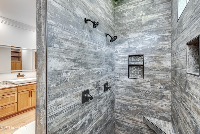 106 Horseshoe Ln, Flora, MS 39071 - full bath featuring tiled shower, vanity, and ornamental molding