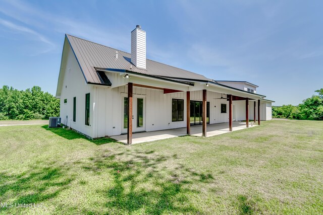 106 Horseshoe Ln, Flora, MS 39071 - back of house with a chimney, central AC unit, a ceiling fan, a patio area, and a yard