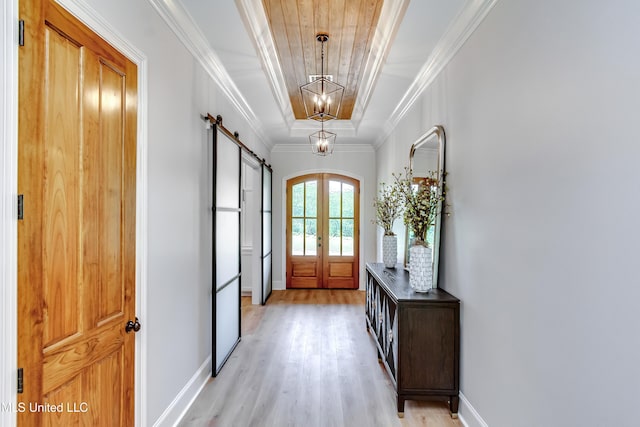 106 Horseshoe Ln, Flora, MS 39071 - foyer with a barn door, light wood-style flooring, a chandelier, baseboards, and crown molding