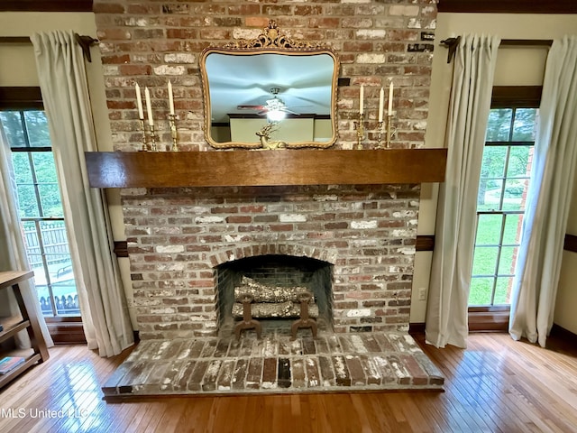 1331 Northwood Cir, Carthage, MS 39051 - detailed view of wood finished floors, a ceiling fan, and a fireplace