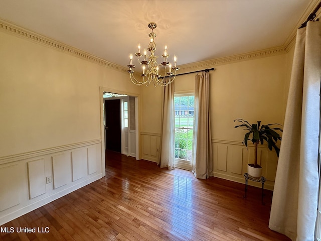1331 Northwood Cir, Carthage, MS 39051 - unfurnished room featuring a decorative wall, wood-type flooring, a chandelier, wainscoting, and crown molding