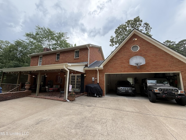 1331 Northwood Cir, Carthage, MS 39051 - view of front of house featuring concrete driveway, brick siding, an attached garage, french doors, and a chimney