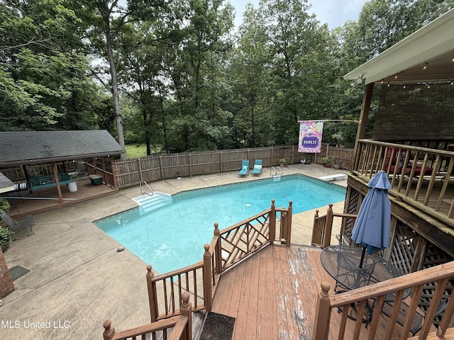 1331 Northwood Cir, Carthage, MS 39051 - view of swimming pool featuring a wooden deck, a diving board, and view of wooded area