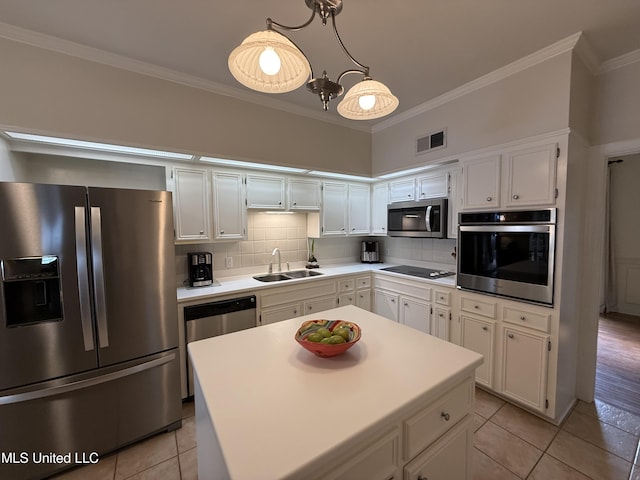 1331 Northwood Cir, Carthage, MS 39051 - kitchen with stainless steel appliances, light tile patterned floors, ornamental molding, light countertops, and white cabinetry