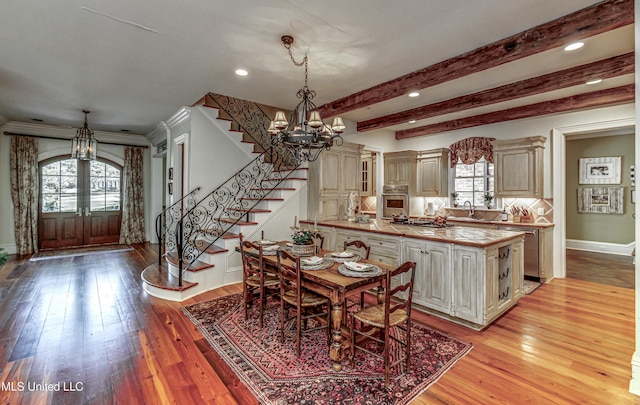 338 Hillview Dr, Ridgeland, MS 39157 - dining area featuring beam ceiling, french doors, sink, and light hardwood / wood-style floors