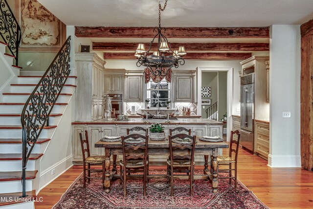 338 Hillview Dr, Ridgeland, MS 39157 - dining space with light wood-type flooring, an inviting chandelier, and beam ceiling