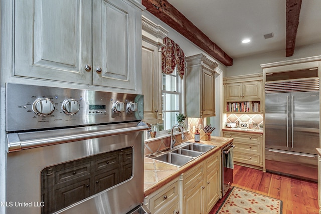 338 Hillview Dr, Ridgeland, MS 39157 - kitchen with backsplash, beam ceiling, sink, light wood-type flooring, and appliances with stainless steel finishes