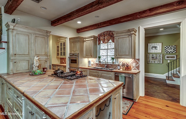 338 Hillview Dr, Ridgeland, MS 39157 - kitchen featuring appliances with stainless steel finishes, tile countertops, light hardwood / wood-style flooring, and sink