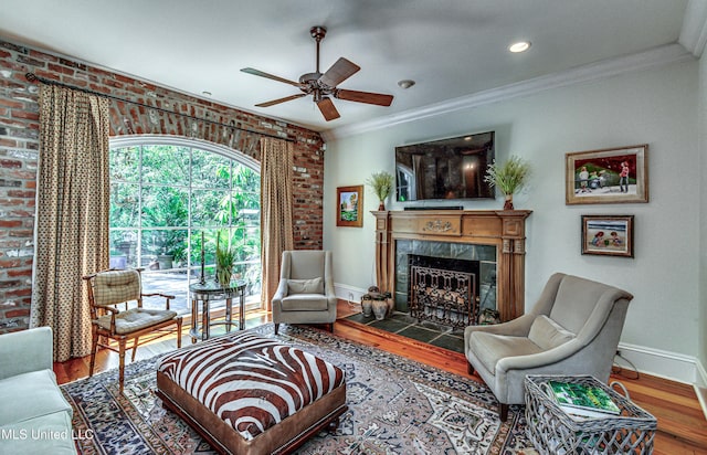 338 Hillview Dr, Ridgeland, MS 39157 - living room with brick wall, hardwood / wood-style floors, crown molding, and a fireplace