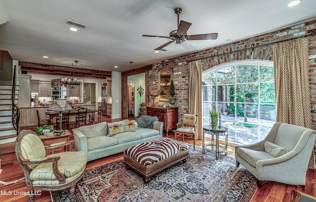 338 Hillview Dr, Ridgeland, MS 39157 - living room with a textured ceiling, brick wall, ceiling fan with notable chandelier, and wood-type flooring