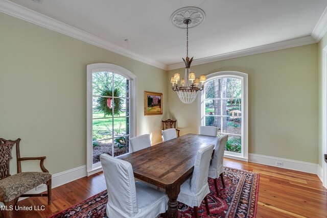 338 Hillview Dr, Ridgeland, MS 39157 - dining room with a chandelier, a wealth of natural light, ornamental molding, and hardwood / wood-style flooring