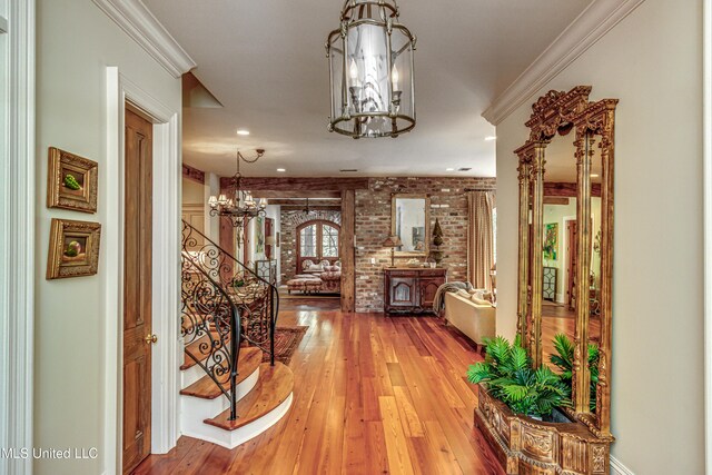 338 Hillview Dr, Ridgeland, MS 39157 - hall with hardwood / wood-style flooring, brick wall, ornamental molding, and a chandelier