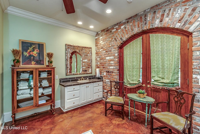 338 Hillview Dr, Ridgeland, MS 39157 - sitting room featuring sink, tile patterned floors, brick wall, and crown molding