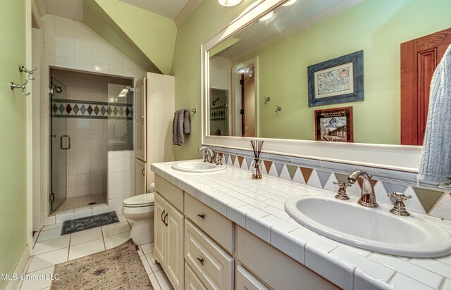 338 Hillview Dr, Ridgeland, MS 39157 - bathroom featuring toilet, vanity, tile patterned flooring, ornamental molding, and a shower with door