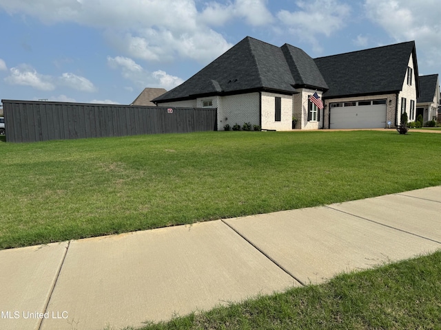 view of home's exterior with a yard and a garage