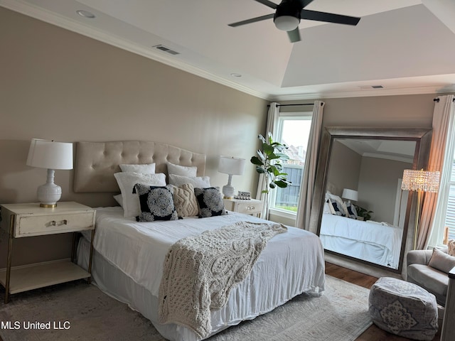 bedroom with lofted ceiling, hardwood / wood-style flooring, ornamental molding, and ceiling fan