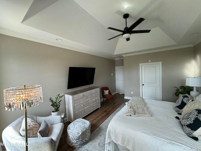 bedroom featuring crown molding, a tray ceiling, dark hardwood / wood-style floors, and ceiling fan