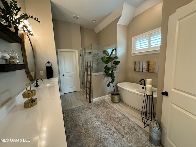 bathroom featuring vanity, independent shower and bath, and wood-type flooring