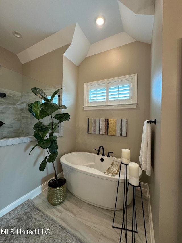 bathroom with lofted ceiling and shower with separate bathtub