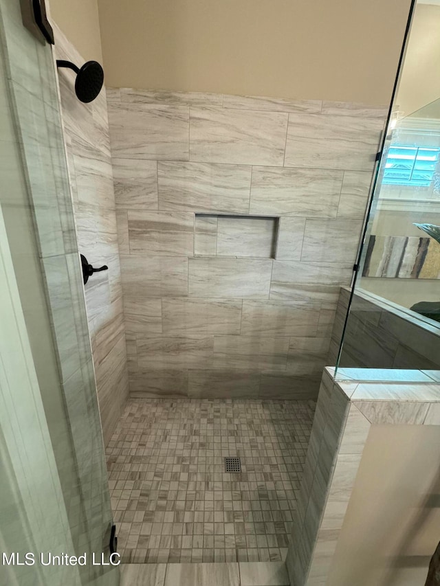 bathroom with a tile shower