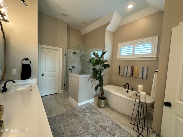 bathroom with vanity, vaulted ceiling, independent shower and bath, and wood-type flooring